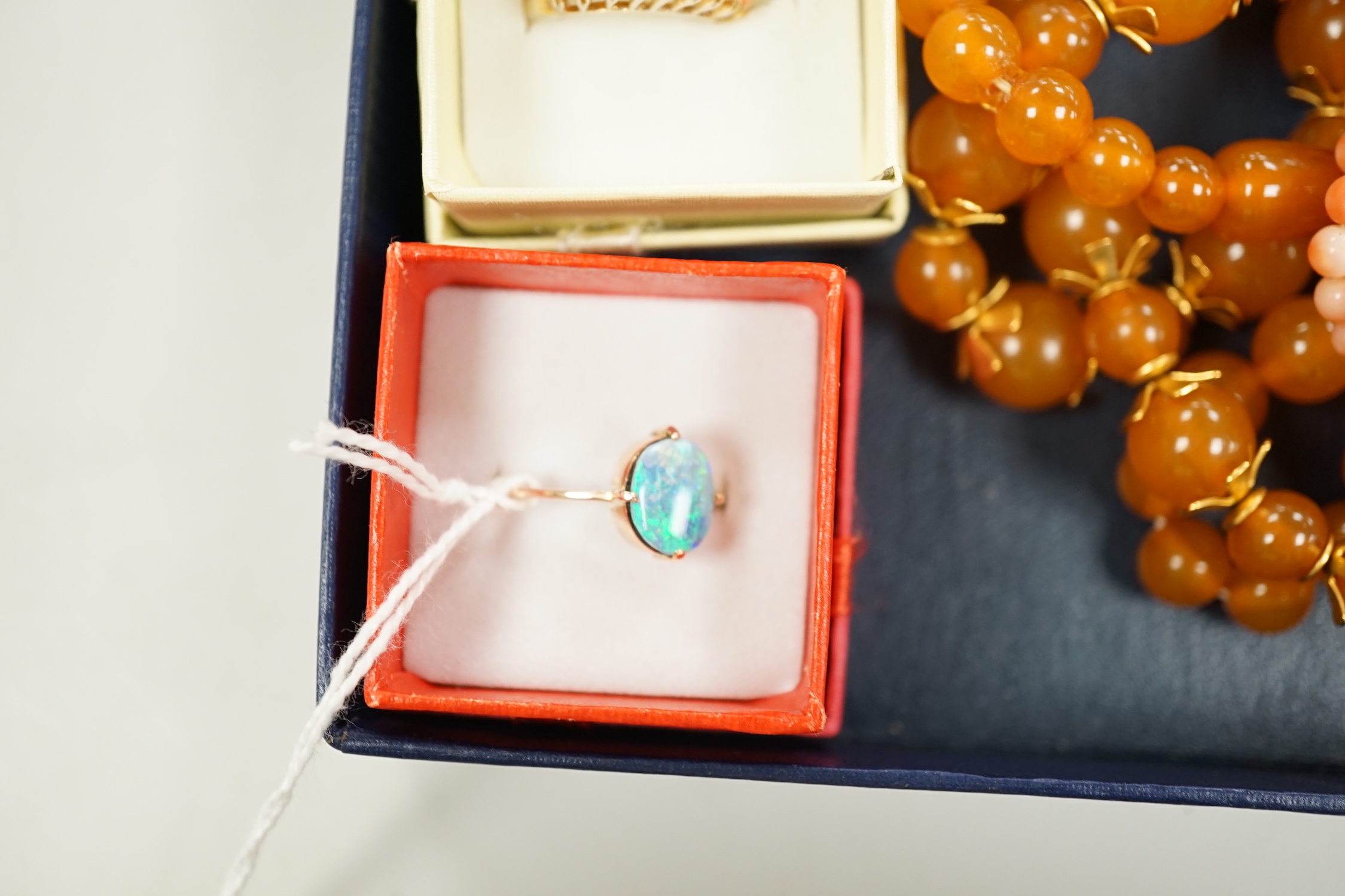 A 9ct and opal doublet ring, two other 9ct and gem set rings, an Edwardian yellow metal and swivelling carnelian ring and six assorted necklaces.